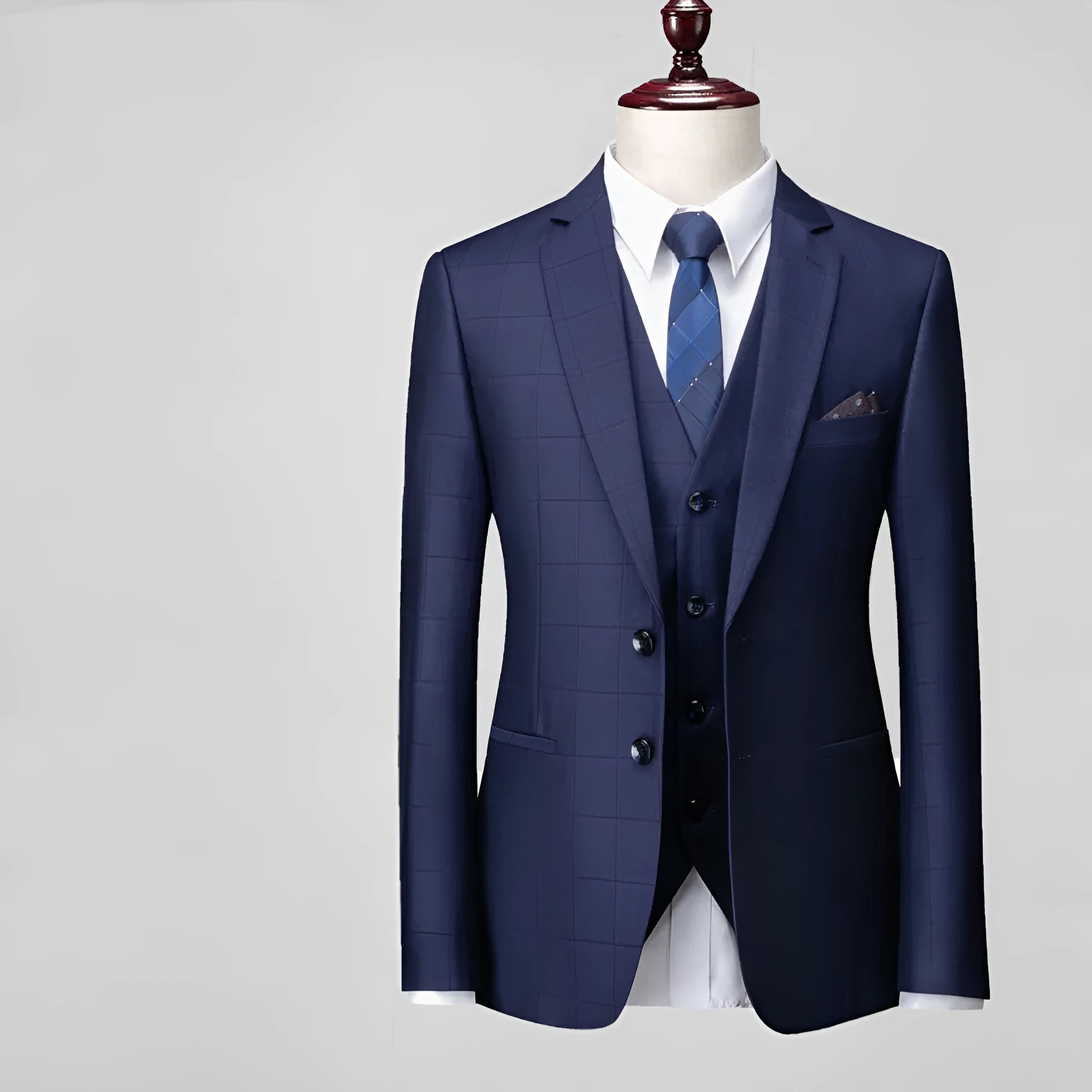 Men's navy blue slim fit plaid three-piece suit with vest, jacket, and trousers on a hanger.