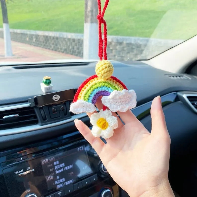 Handmade crocheted car pendant with avocado and rainbow colours hanging from rear-view mirror