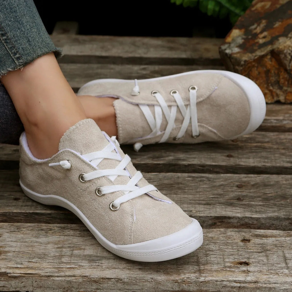 Women's creamy white casual sneakers with fabric upper and rubber sole on multiple surfaces