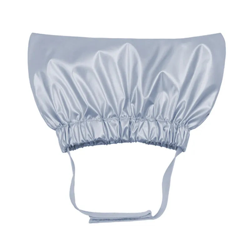 A silver adjustable waterproof shower cap for a dog or cat on a non-woven fabric background.