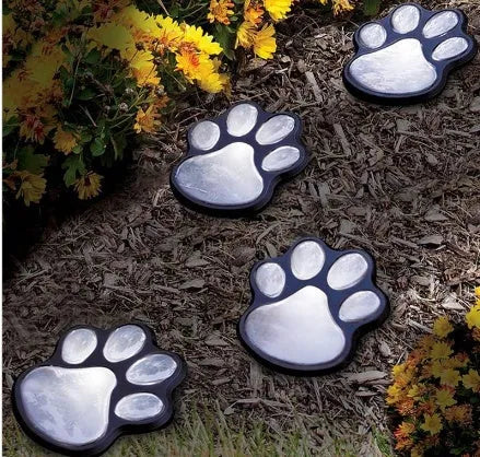 Black solar powered bear paw print garden lights set with four lights and solar panel