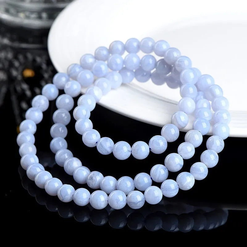 Blue agate bracelet with natural striped beads and Ruyi design elements