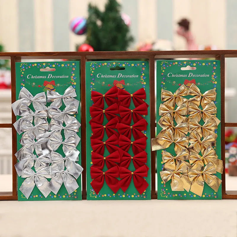 Red and gold 5 cm polyester Christmas decoration bow on a green tree branch.