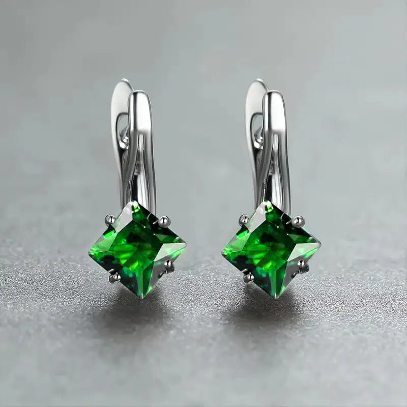 A pair of women's copper earrings with an inlaid zircon diamond design, shown in blue, green, and colour variations.