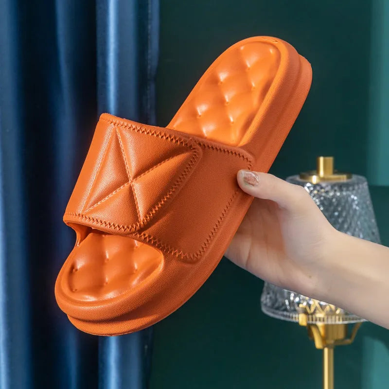 Soft EVA non-slip bathroom slippers with thick sole in assorted colours on a bathroom floor.