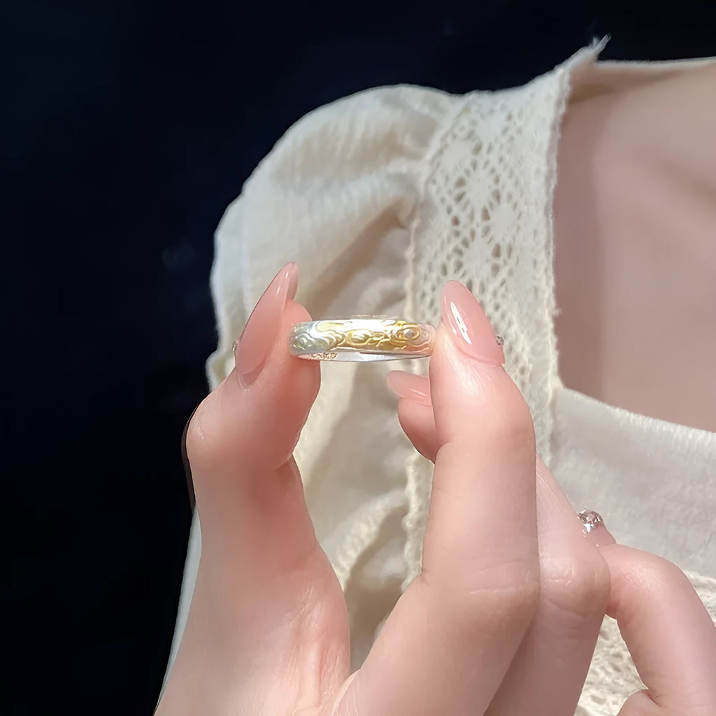 Open mouth silver and gold ring with a geometric Xiangyun pattern on a white copper band.