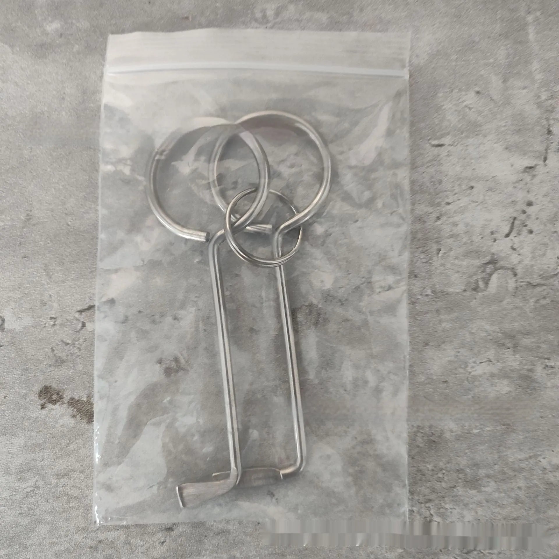 Two alloy steel wrench tools from a portable household repair set.