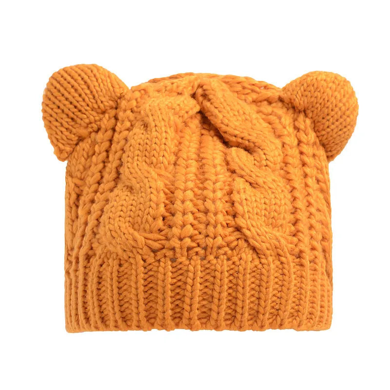 Hand-made chunky wool beanie with 3D knitted cat ears on a white background.