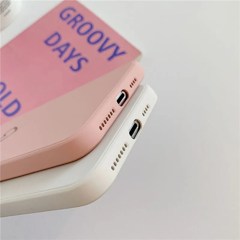 Silicone TPU back cover case for iPhone in solid colours like black, pink, and green on a white background.
