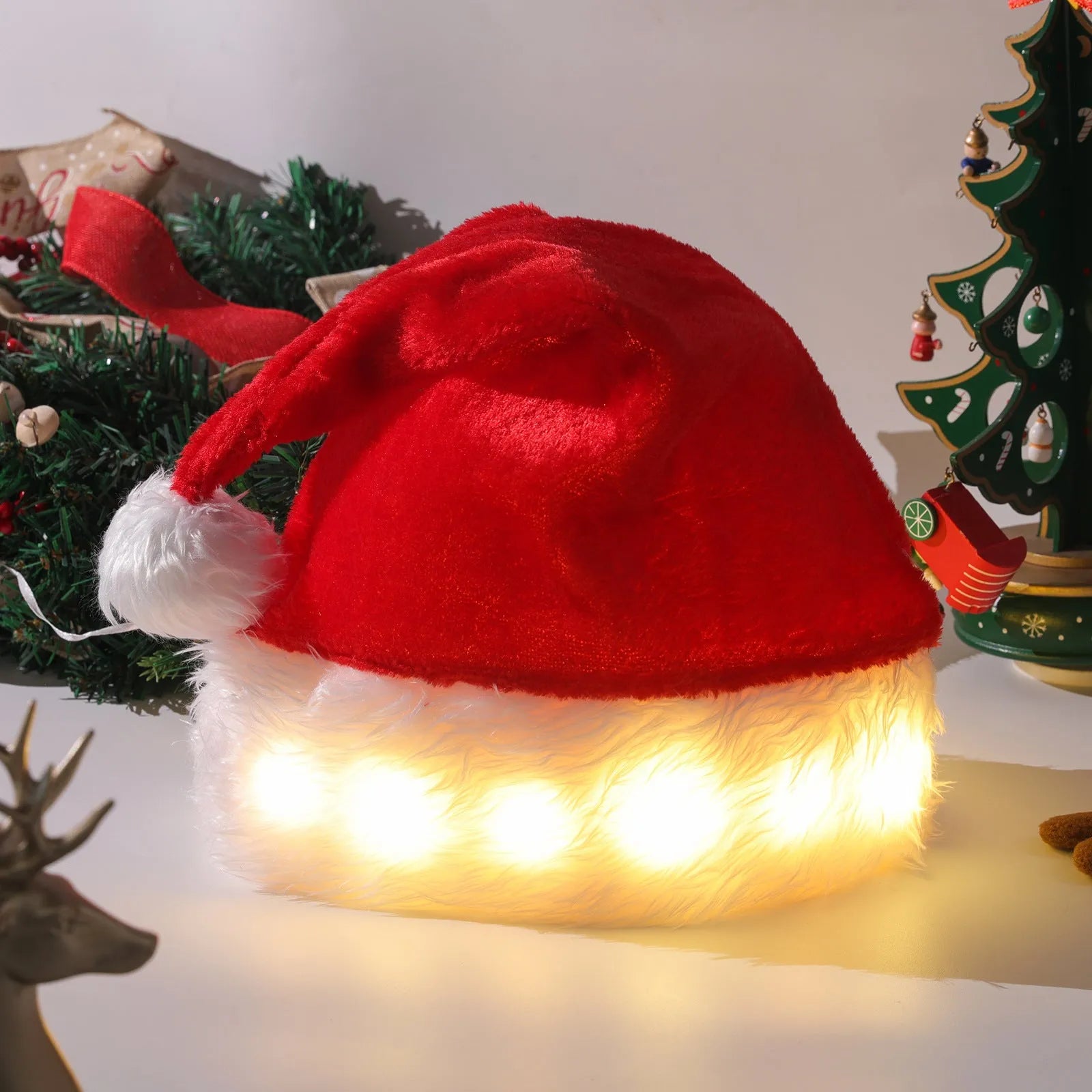 Red and white plush LED Santa hat with pom-pom and multi-coloured twinkling lights on.