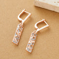 Rectangular two-tone hollow stud earrings with geometric openwork centre and electroplated finish
