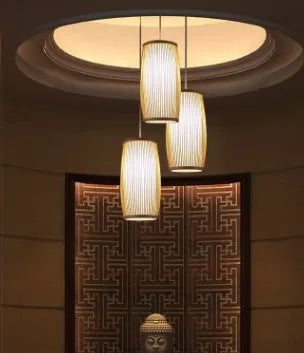 Natural bamboo plait cylindrical wall lamp with woven texture, shown mounted.
