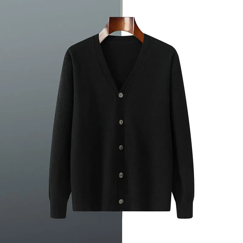 Man wearing a beige V-neck Andy velvet knitted cardigan coat with long sleeves and a loose fit.