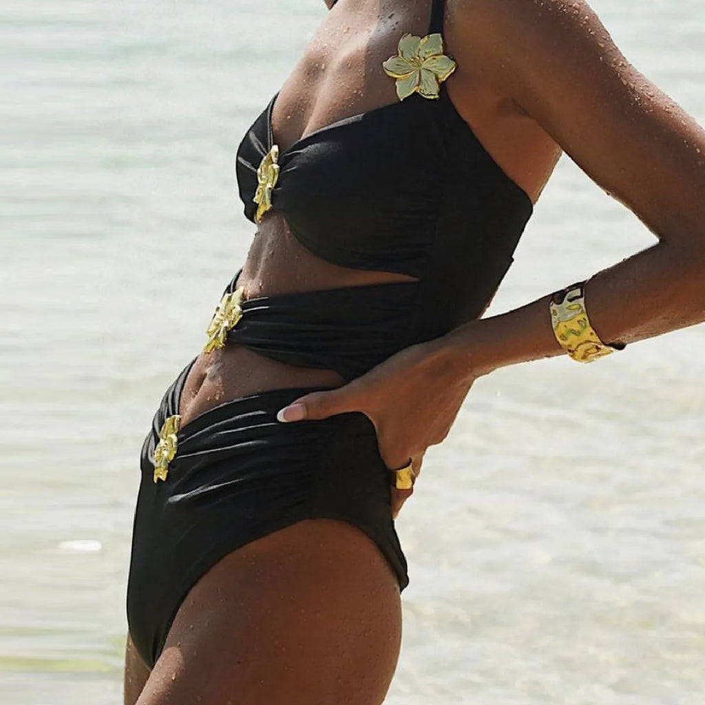 Women's black one-piece swimsuit with matching skirt and hollow-out tube top design