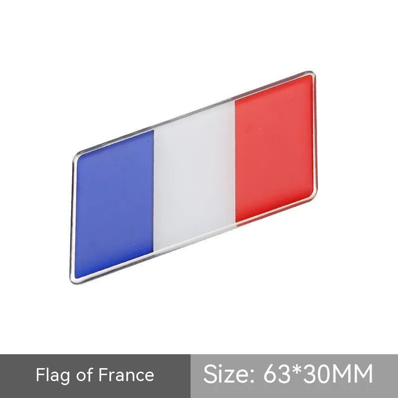 Aluminium parallelogram car sticker with national flag design measuring 6.3 by 3 cm