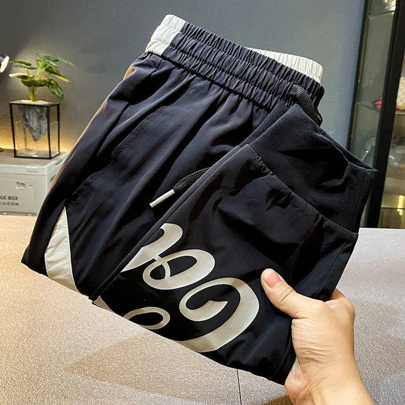 Black men's ultra-thin cotton cropped trousers with elasticated ankle banding.