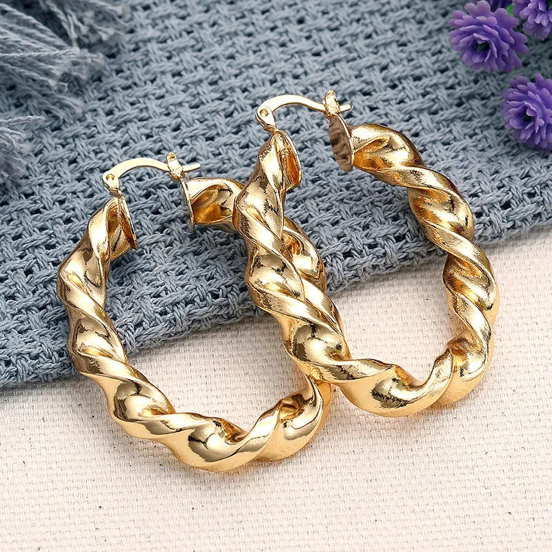 Women's geometric drop earrings with clip-on fastening in copper with ring and line design elements