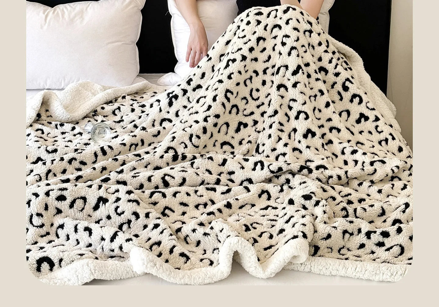 Double-layer Jacquard taffeta blanket with leopard print design in camel colour folded to show texture and pattern detail