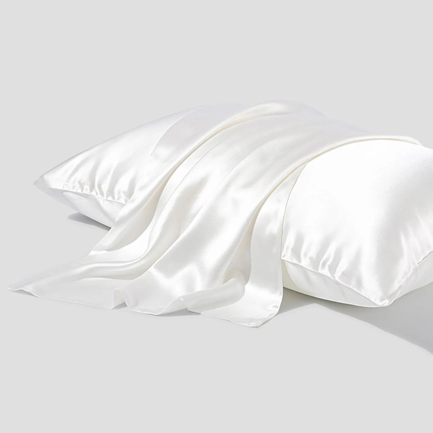 Dark grey silk pillowcase with envelope closure, shown flat and on a pillow.