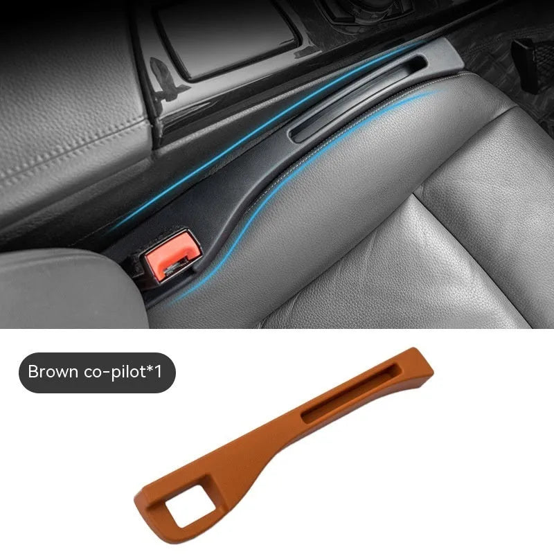 Black car gap storage box with handle positioned between car seats