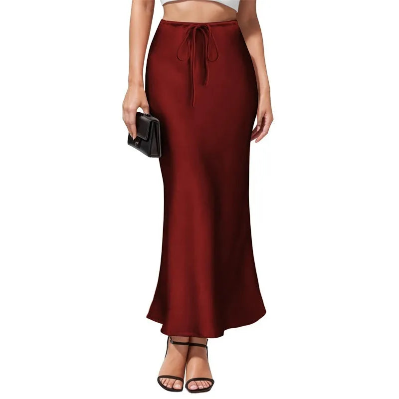High-waisted asymmetric acetate skirt in a solid colour with irregular stitching detail on the hem.