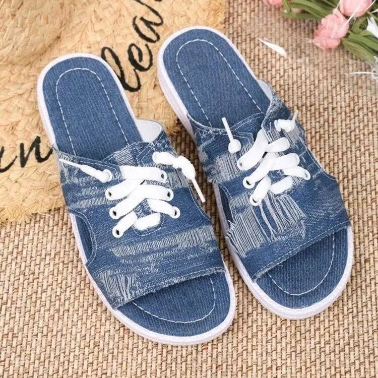 Blue women's flat canvas Roman style slippers with a cloth upper and rubber sole.
