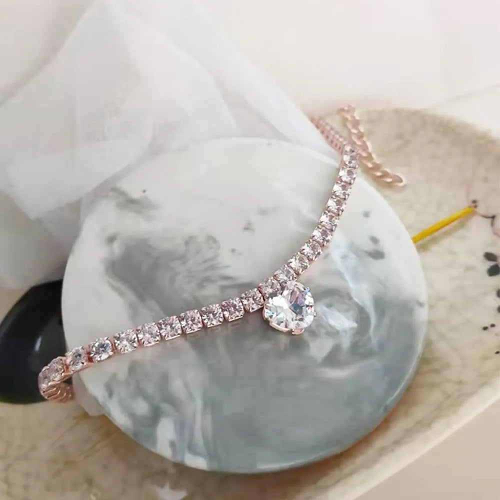 Gold rhinestone heart-shaped collar for dogs and cats with shiny stones and metal extension chain.