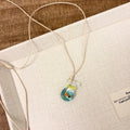 Women's pendant necklace with coloured glaze skirt joker charm on cotton linen clavicle chain