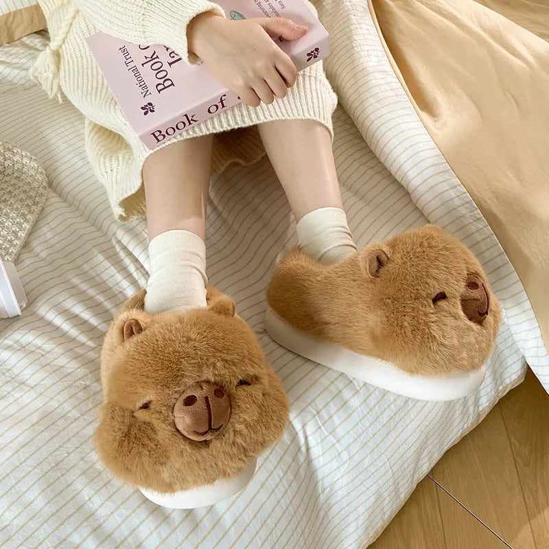 Light brown women's plush winter slippers with cartoon pattern and artificial wool lining.