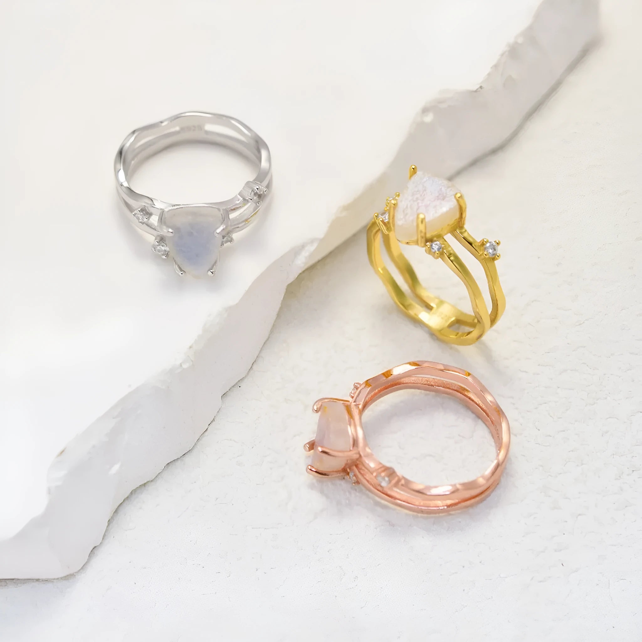 S925 silver ring with triangular shape and central moonstone in rose gold, white, or yellow gold finish.