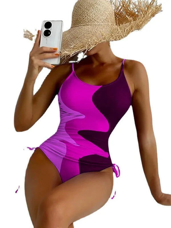 Women's sleeveless backless one-piece swimsuit in blue, shown on a mannequin.