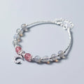Handmade adjustable moonstone bracelet with crescent moon charm and crystal bead on wrist.