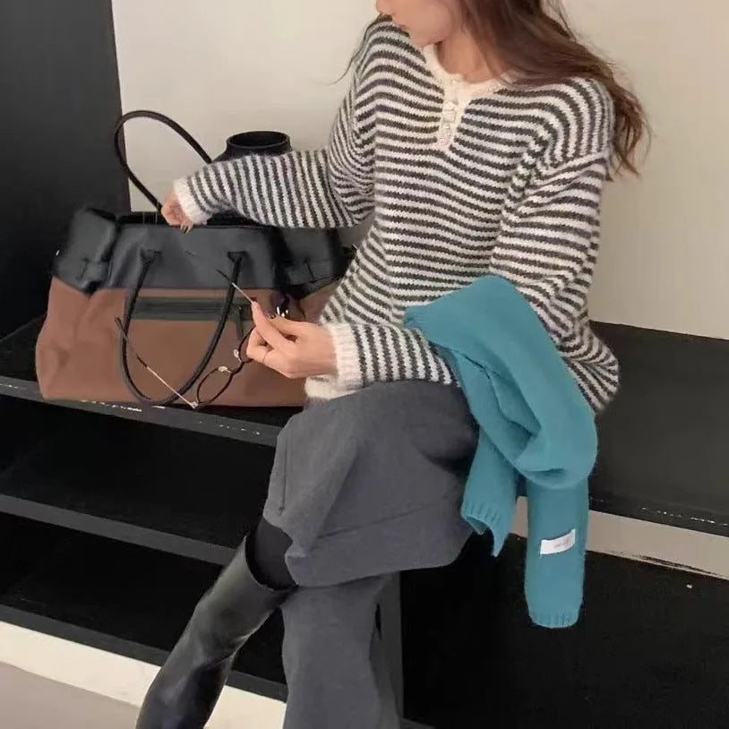 Red and blue striped cashmere pullover sweater for women with loose fit and long sleeves.