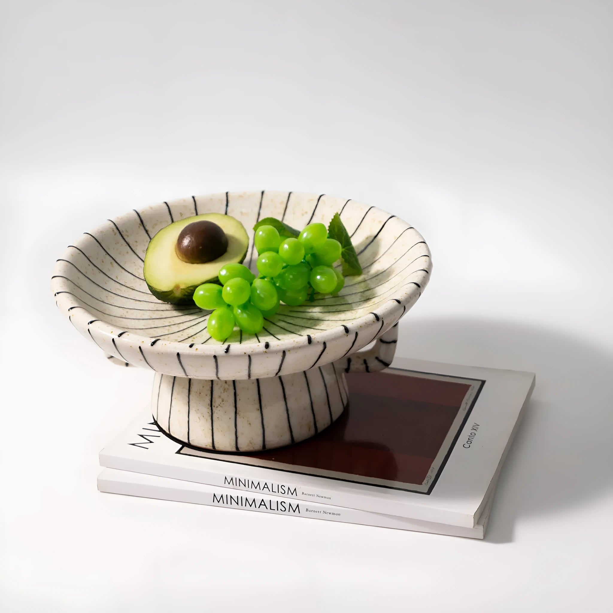 Black and white striped resin fruit plate on a table for dessert serving.
