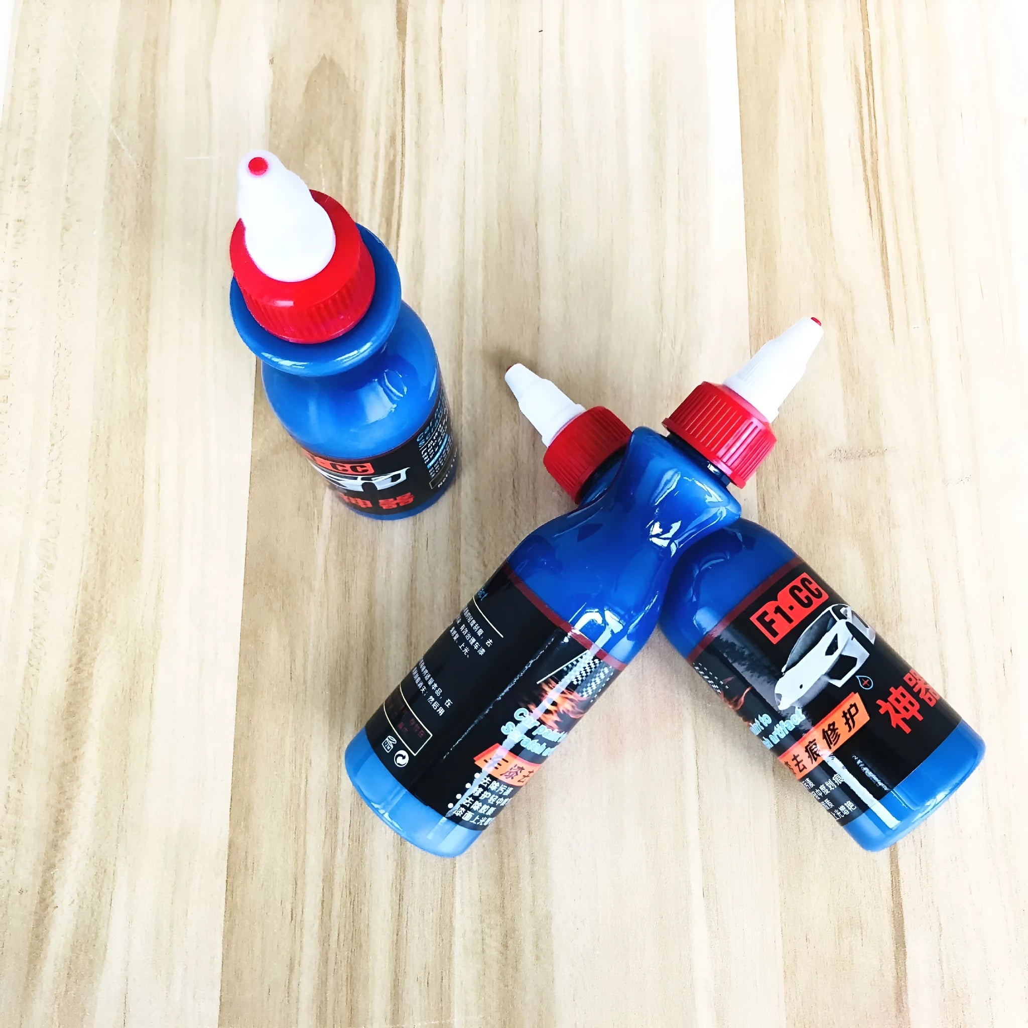 Small blue bottle of 30ml car scratch repair agent with applicator brush for automotive paint touch-ups