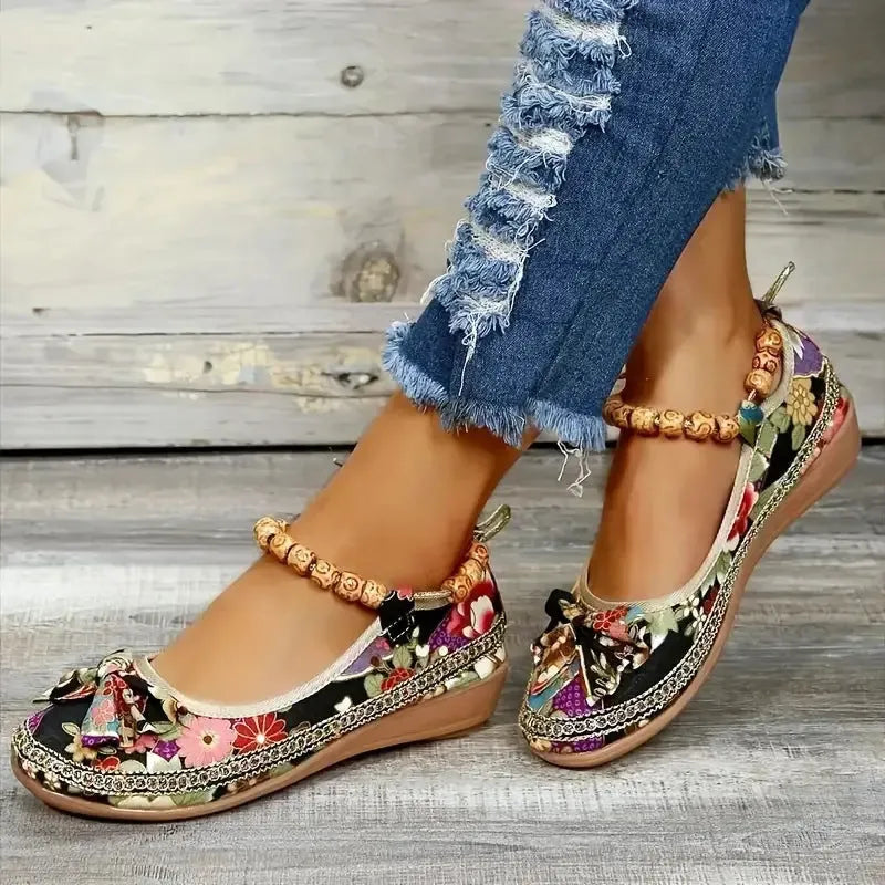 Women's black ethnic style platform sandals with elastic band closure, fabric upper, and round toe.