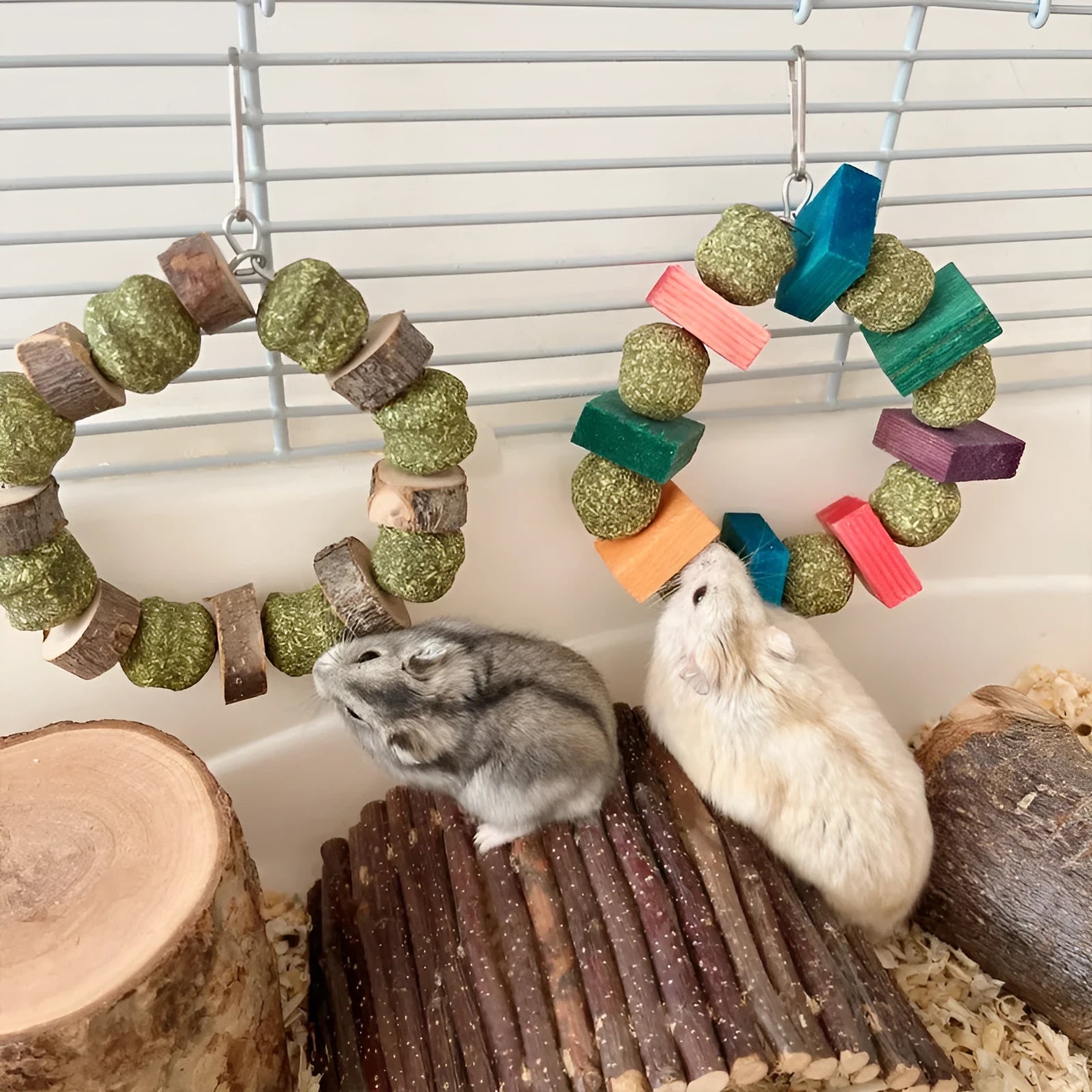 Applewood and woven straw ball chew ring toy for small pets on a white background.