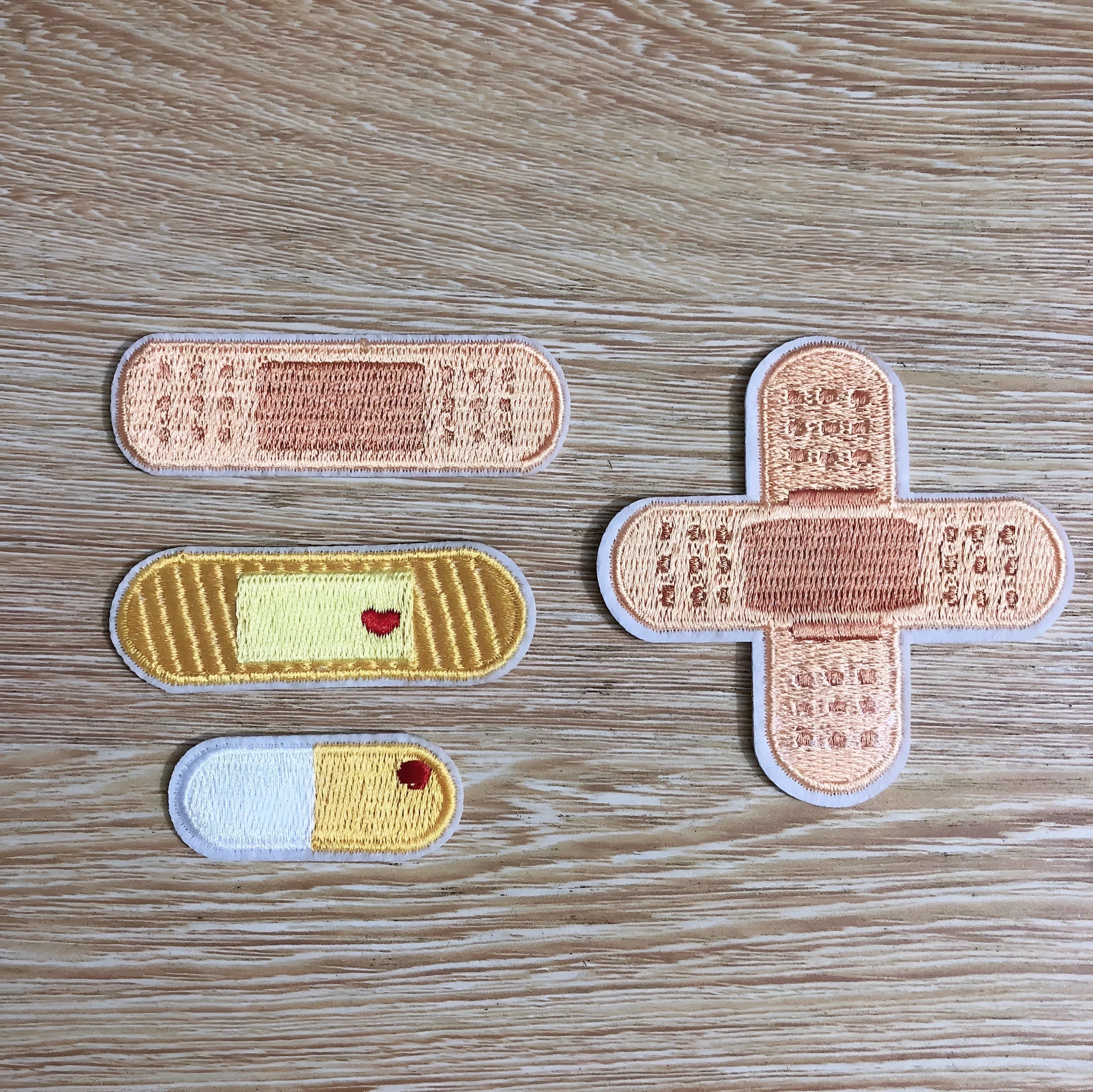 Ten computer embroidered fabric patches with detailed raised designs for clothing decoration
