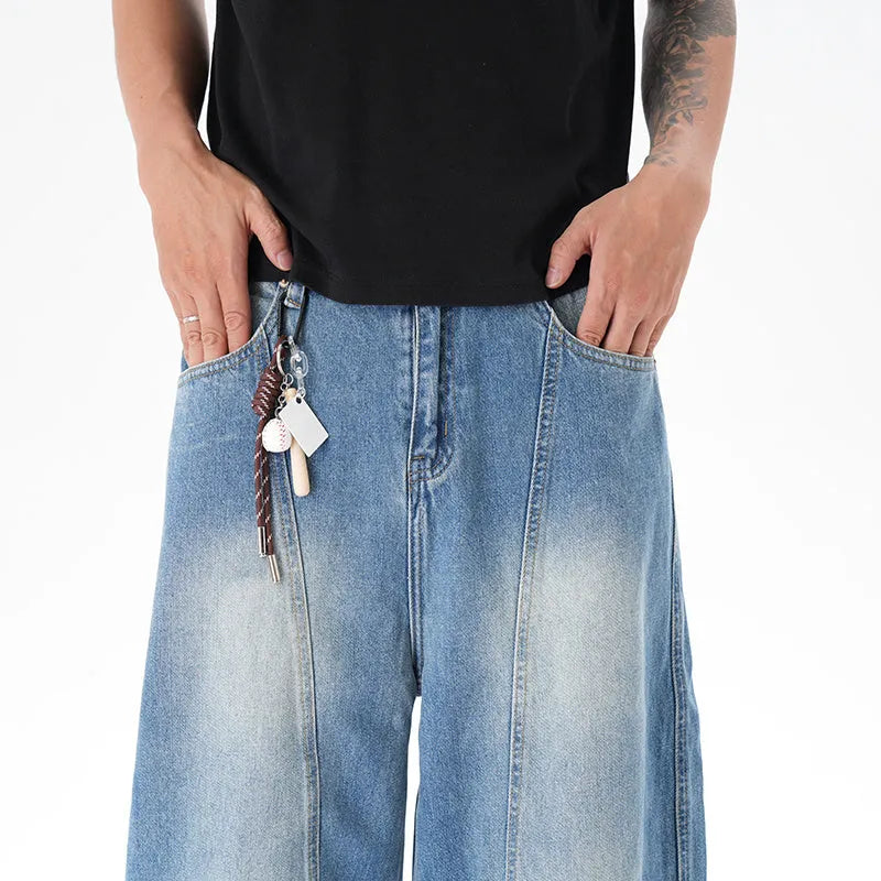Light blue vintage washed wide leg machete jeans with a straight fit and zipper fly on a model.