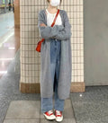 Women's knitted V-neck cardigan in loose fit showing mid-length silhouette and long sleeves