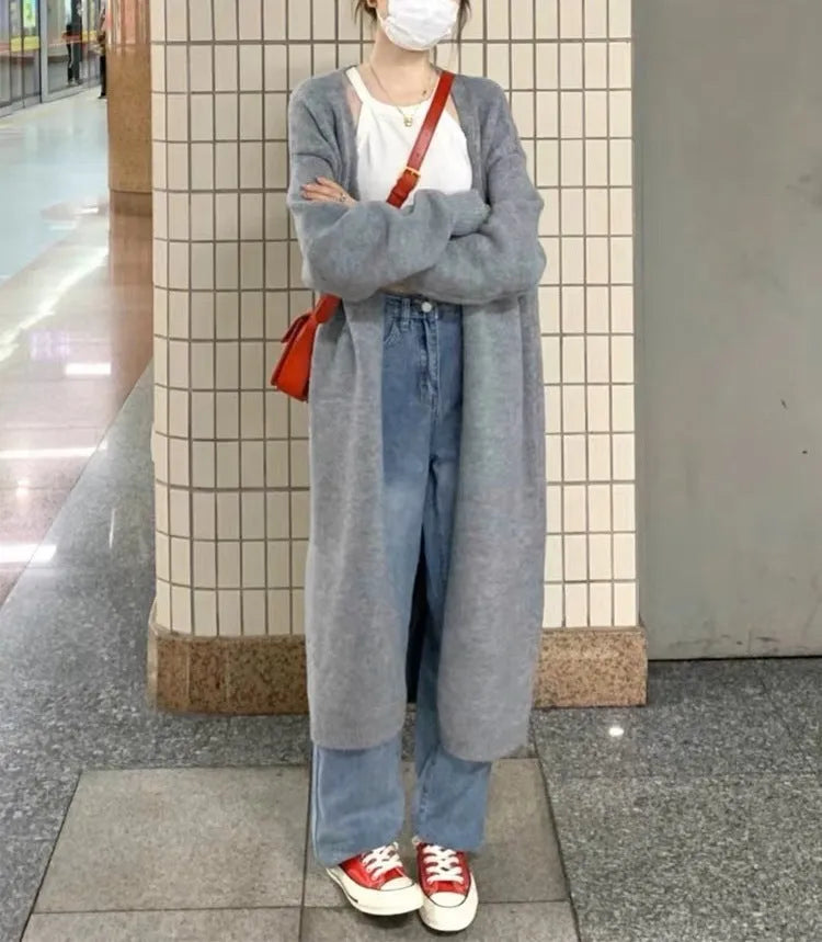 Women's knitted V-neck cardigan in loose fit showing mid-length silhouette and long sleeves
