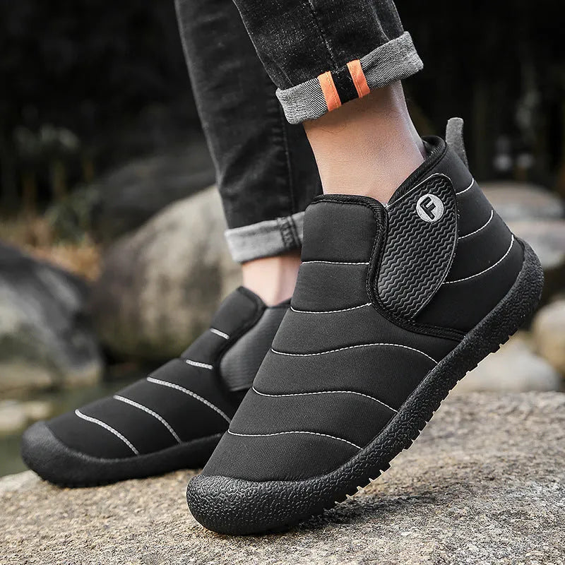 Men's waterproof snow boots in black with thick cotton upper and rubber sole.