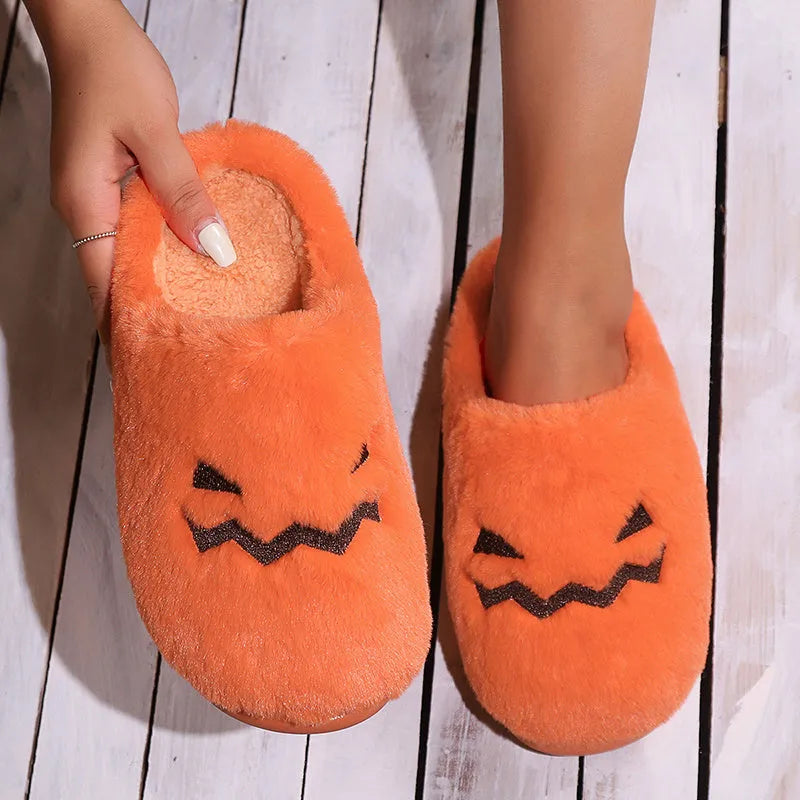 Orange Halloween pumpkin slippers with plush construction and non-slip soles in paired adult sizes