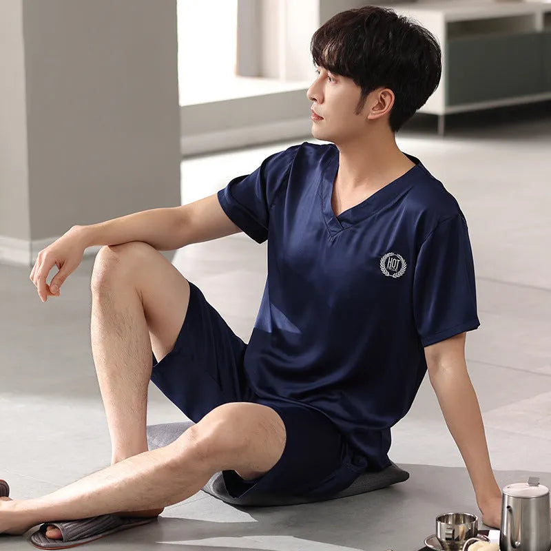 Man's light blue ice silk pyjama set with short sleeves and loose shorts laid flat.