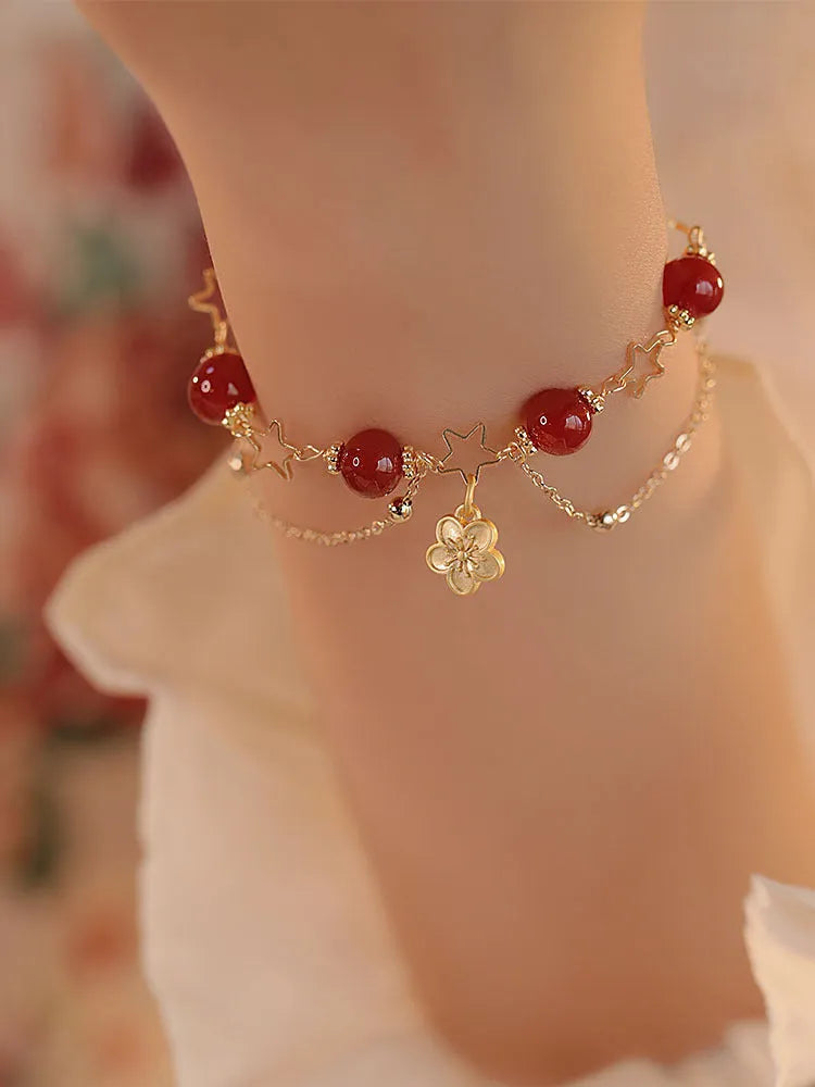 Red agate double layer bracelet for women with carved peach blossom and flower designs.