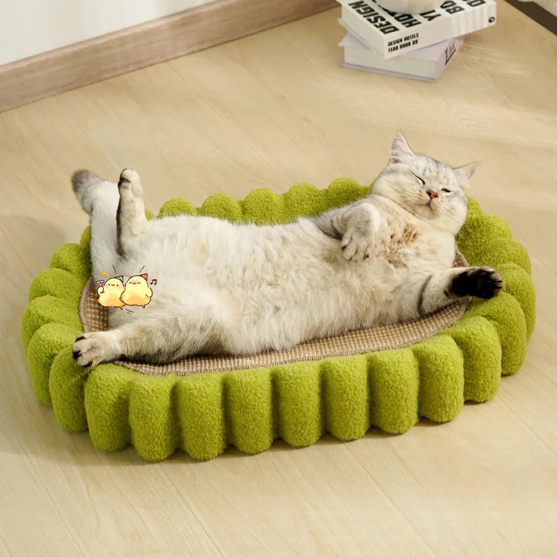 Green oval sisal cat scratching pad serving as a lounging bed, dimensions 650mm by 420mm.