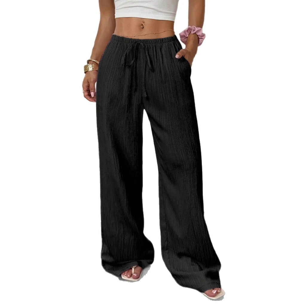 Women's black wide-leg trousers with lace-up waist trimming detail on hanger
