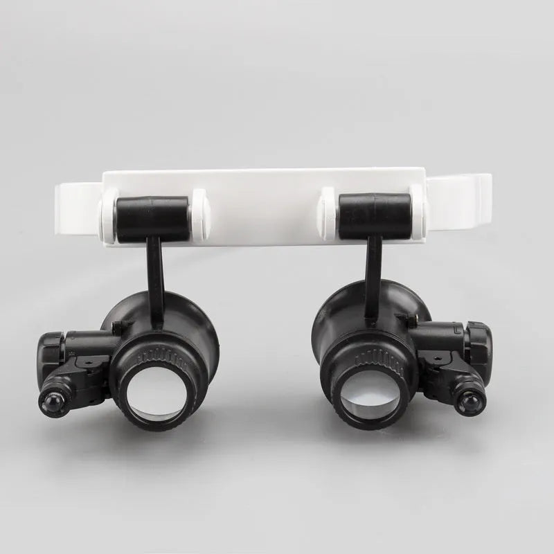 White head mounted magnifying glass with folding arms and LED light for watch and circuit board repair