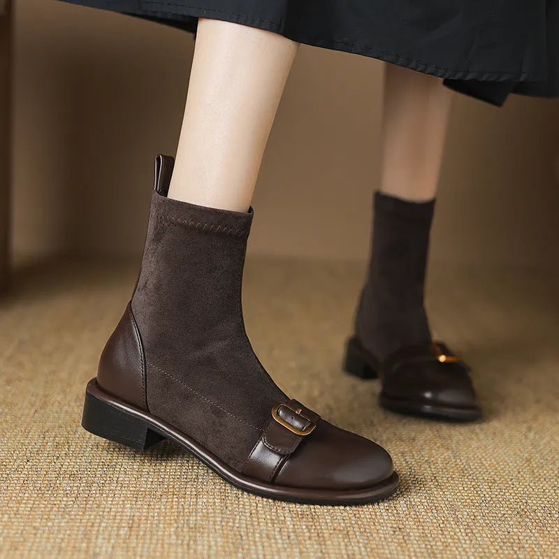 Women's black casual Martin ankle boots with lace-up front and buckle stitching detail on a low heel.