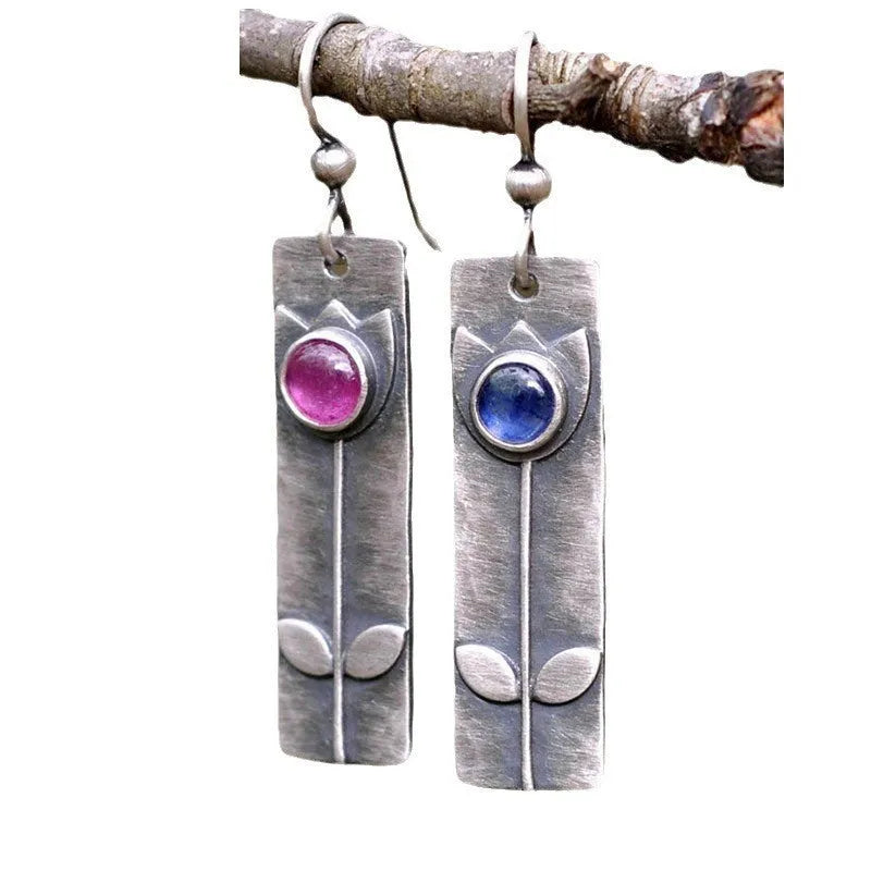 Red sapphire earrings with antique metal finish and geometric ellipse design